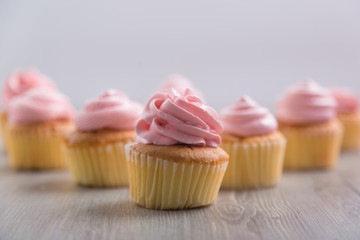 Tasty cupcakes on wooden table