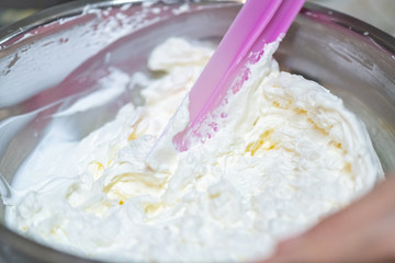 whipped cream cooking process.woman mixing Fresh cream for making whipped cream or desserts and bekery.woman making whipped cream and show process with stand or hand mixer.