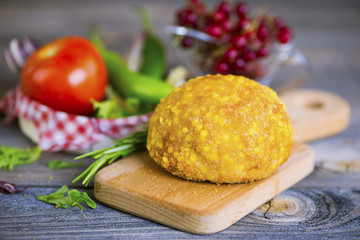 cutlet from turkey meat in batter on an old wooden background