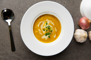 roasted pumpkin soup with herbs top view