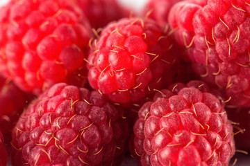 Raspberry on a background of gray cement. Ripe and juicy fresh raspberries. A lot of berries close-up.