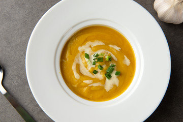 roasted pumpkin soup with herbs top view