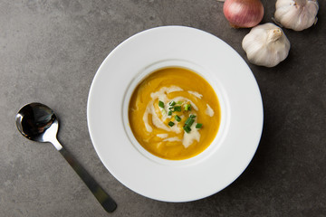 roasted pumpkin soup with herbs top view