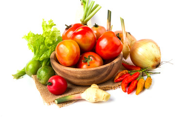 fruits and vegetables in wooden bowl on white background, tomato, lemon, chilli