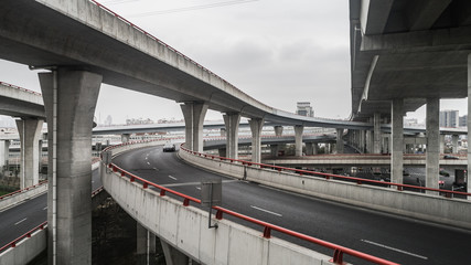Aerial view of highway and overpass in city on a cloudy day