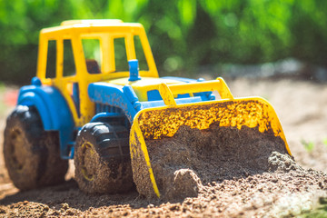 toy tractor in the sand