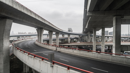 Aerial view of highway and overpass in city on a cloudy day