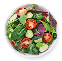 Fresh green salad with tomatoes isolated on white background.