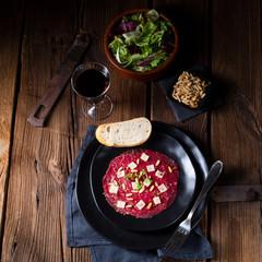 Carpaccio of beef with pine nuts, colorful pepper and Parmesan cheese