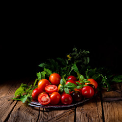 various types of tomatoes served and presented on the silver platter.