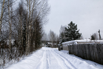 Russian village and wooden house in it in a winter