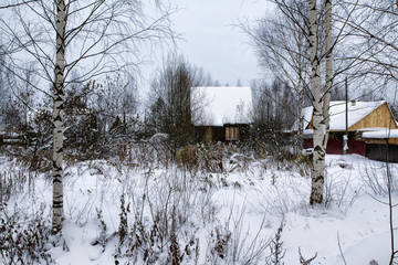Russian village and wooden house in it in a winter