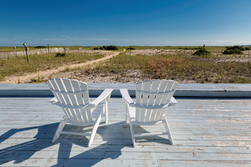 Two beach chairs on a beach at sunset in Cape Cod, New England, Massachusetts, USA