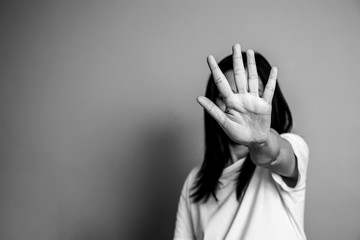 woman raised her hand for dissuade, campaign stop violence against women. Asian woman raised her...