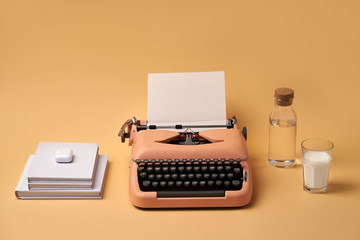 Composition with typewriter, books, glass and bottle