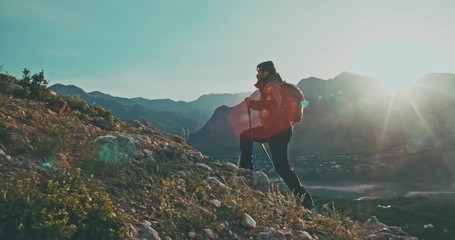 Young mountaineer hiking up a mountain. Adventurer climbing up. Adventures, zen concept 4k