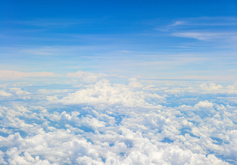 Beautiful view of blue sky above the white clouds from airplane window