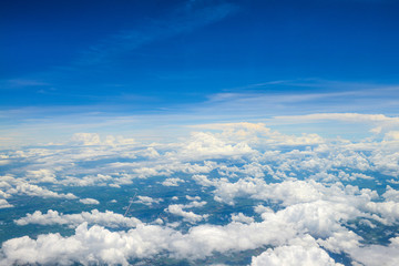 Naklejka na ściany i meble Beautiful view of blue sky above the white clouds from airplane window