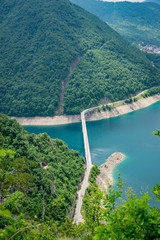 A picturesque turquoise lake can be seen from the top of a high mountain.