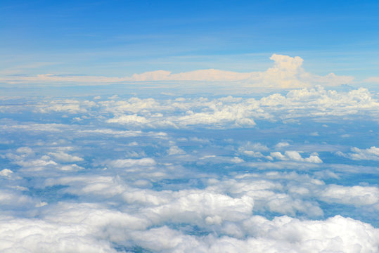 Beautiful view of blue sky above the white clouds from airplane window © opasstudio