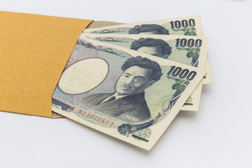 Japanese banknote 1,000 yen in brown envelope for give and business success and shopping. Business Concept