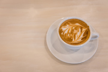 Latte art coffee cup on marble table