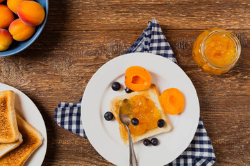 Breakfast. Toasts with cherry or peach jam and fresh fruit.
