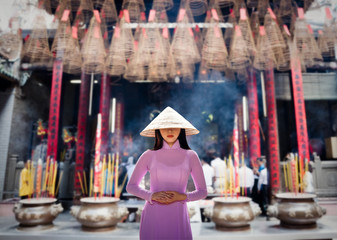 Young Vietnam woman wearing Ao Dai culture traditional at old temple at Ho Chi Minh in Vietnam,vintage style,travel and relaxing concept. - 213583699