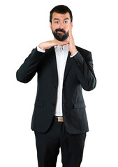 Handsome businessman making time out gesture