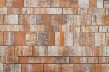 Masonry made of smooth polished stone slabs of sandstone. Texture of a fragment of a wall of an old structure. A background for design and creative work. Decoration and exterior decoration