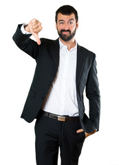 Handsome businessman making bad signal