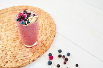 Glass of pink fruit smoothies milkshake or cocktail on white background, breakfast vegan, with a place for your text, concept of raw food