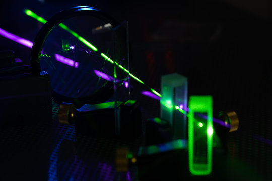 green and blue laser on optical table in physics laboratory