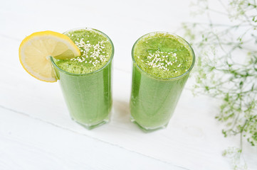 Blended green smoothie with ingredients or cocktail on white background, breakfast vegan with a place for your text, concept of raw food detox