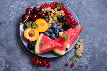 Fresh summer fruits and berries, watermelon, cantaloupe, cherries, red and white current, apricot, vegan raw eating, diet vitamins concept