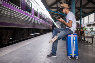 Traveler are backpacking and walking alone at train station.