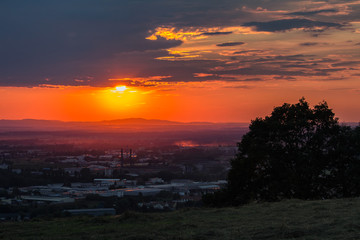 Obraz premium Nice sunset over city Ceske Budejovice with tree silhouette