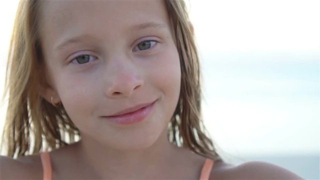 Happy little girl enjoying holiday vacation on the beach