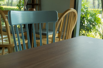 Empty table in front of blur coffee shop.