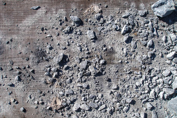 Broken stones with grit on wooden board