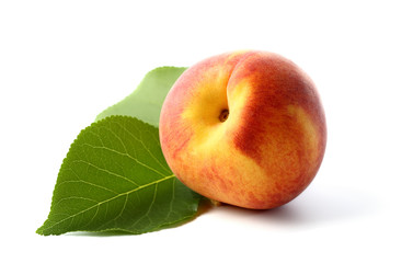 Peach with leaf isolated on a white background