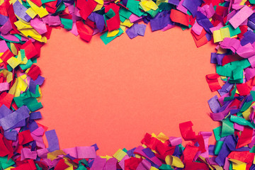 Festive party decor and confetti on pink background