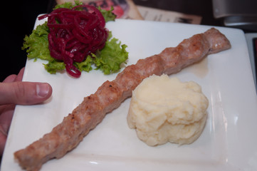 hand  bring plate with fried meat