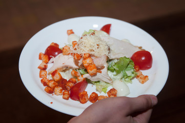 hand  bring plate with fried meat