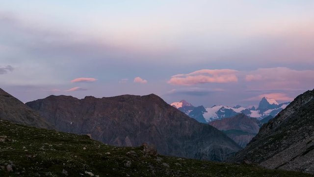 Time lapse twilight sunrise on the Alps. Glaciers and mountain peaks Massif des Ecrins, over 4000 m, France.