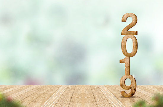 New year 2019 wood number (3d rendering) on wooden plank table at blur abstract green bokeh background,Mock up banner space for display or montage of product,holiday celebration greeting card.