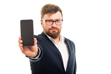 Portrait of business man showing smartphone to the camera.