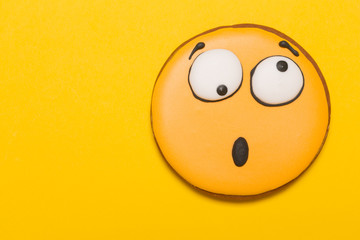 cookie smile and emotion, opened his mouth, surprise, baby gingerbread, on a yellow background, concept
