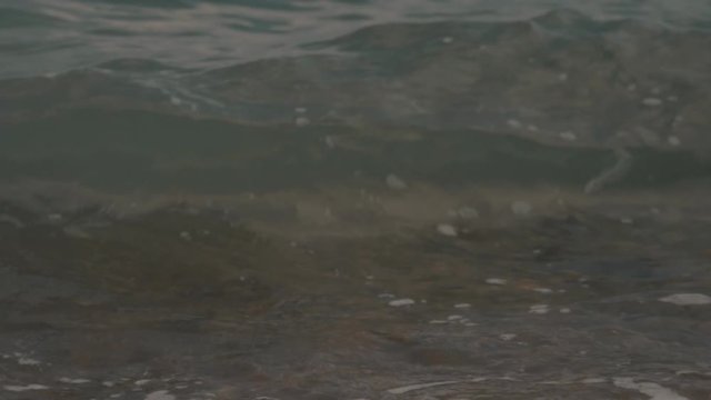 Silky waves on the sea pebbles. Shingle beach