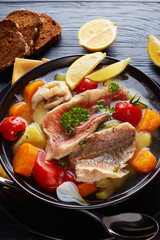 greek psarosoupa in a black bowl